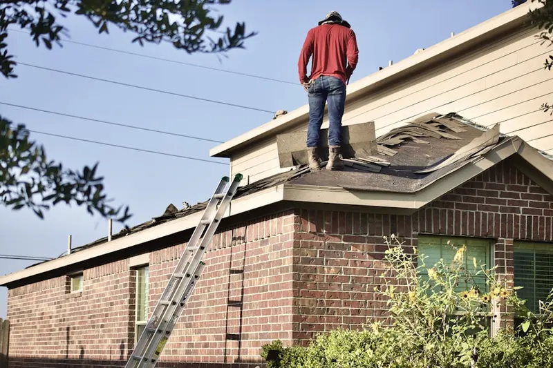 Professional roofer working on a residential roof in Kingwood